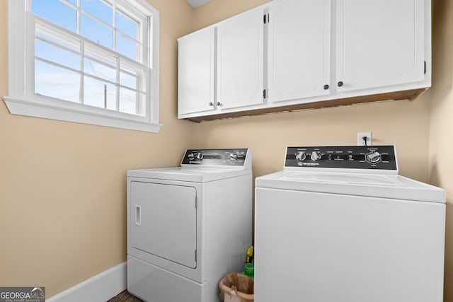 laundry room featuring cabinets and washer and dryer