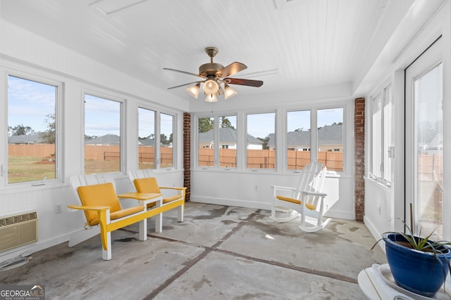 sunroom / solarium featuring a mountain view and ceiling fan