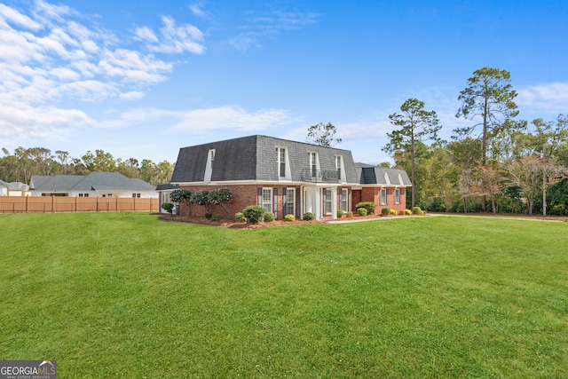 rear view of property featuring a yard