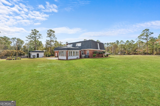 402 Brannen Dr, Statesboro, GA 30458 - rear view of property featuring a lawn, a sunroom, and roof with shingles