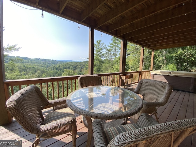 wooden deck featuring a hot tub