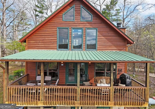 rear view of house featuring metal roof