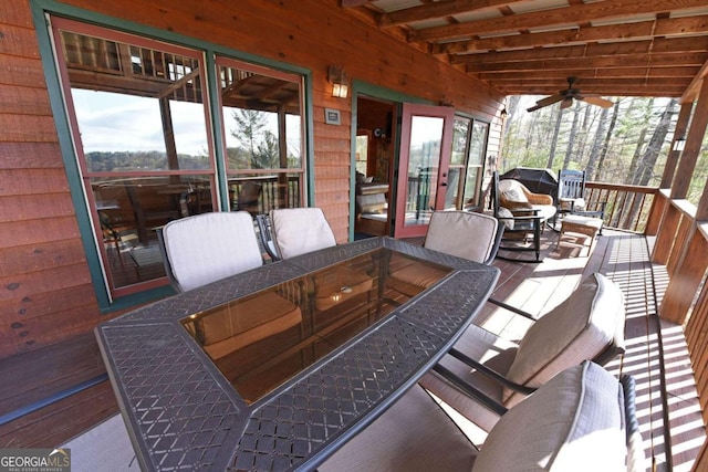 sunroom / solarium with beamed ceiling and a healthy amount of sunlight