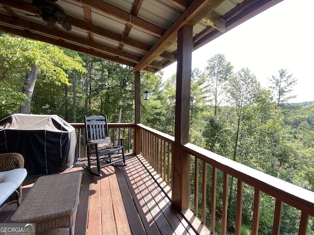 wooden terrace featuring a ceiling fan and area for grilling