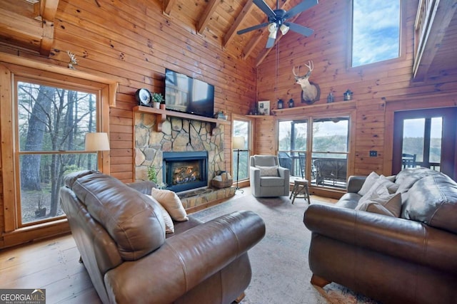 living room with a healthy amount of sunlight, high vaulted ceiling, and beamed ceiling