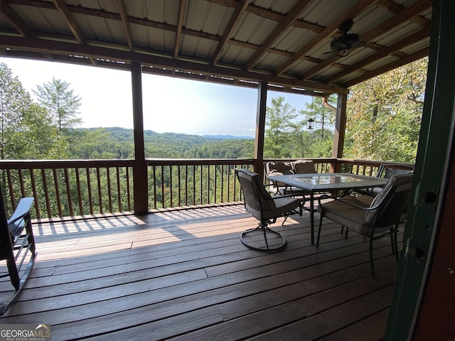 wooden terrace featuring ceiling fan