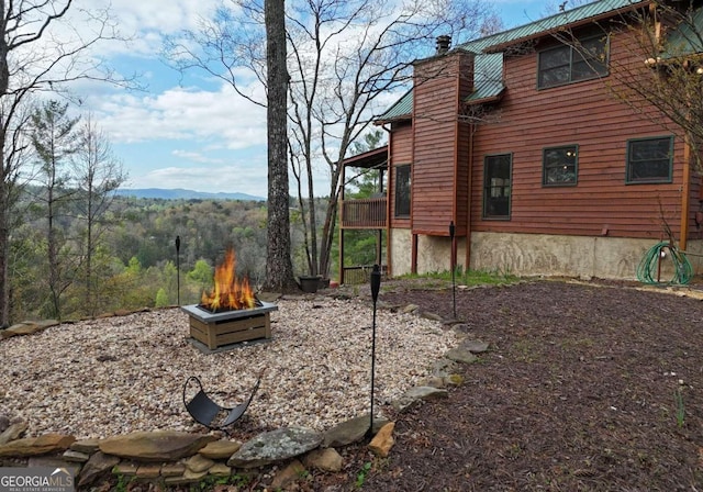 view of yard with a mountain view and a fire pit