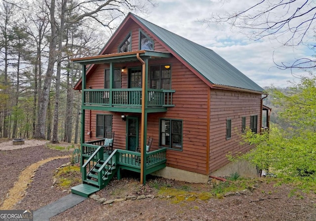 chalet / cabin with a balcony and metal roof