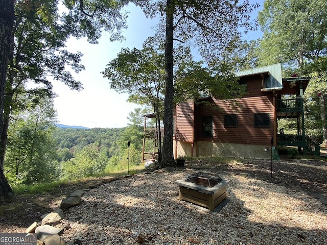 view of yard with a fire pit and a deck