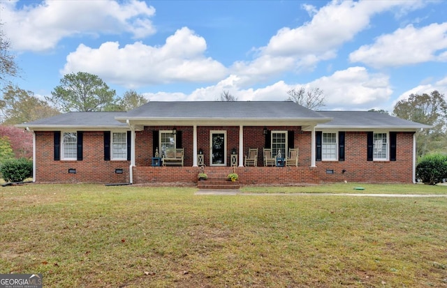 ranch-style house with a front yard and covered porch