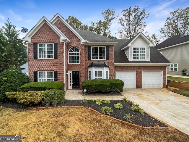 view of front of house featuring a garage and a front lawn