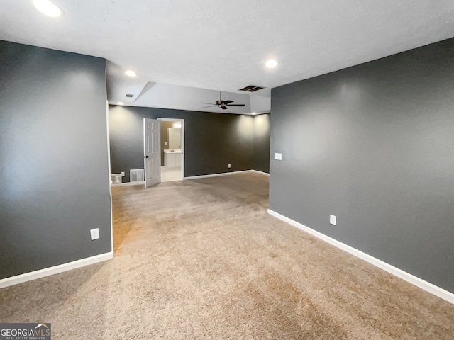 spare room featuring ceiling fan and carpet flooring