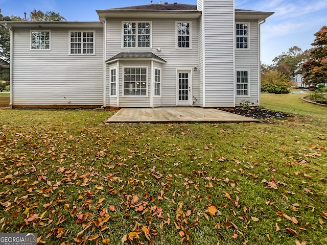 back of property featuring a patio area and a lawn