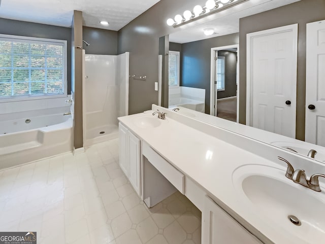 bathroom featuring vanity and separate shower and tub