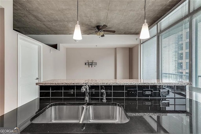 interior space featuring sink, pendant lighting, and ceiling fan