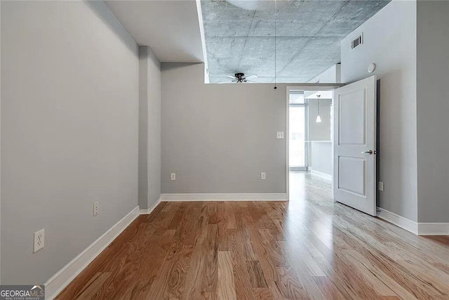 unfurnished room featuring ceiling fan and light wood-type flooring