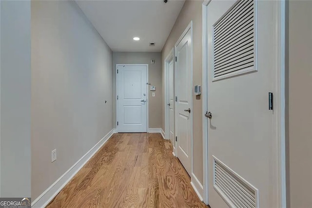 corridor with light hardwood / wood-style flooring