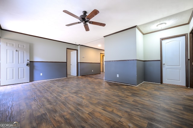 spare room featuring ornamental molding, dark wood-type flooring, and ceiling fan