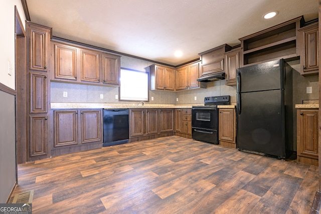 kitchen featuring backsplash, black appliances, and dark hardwood / wood-style floors