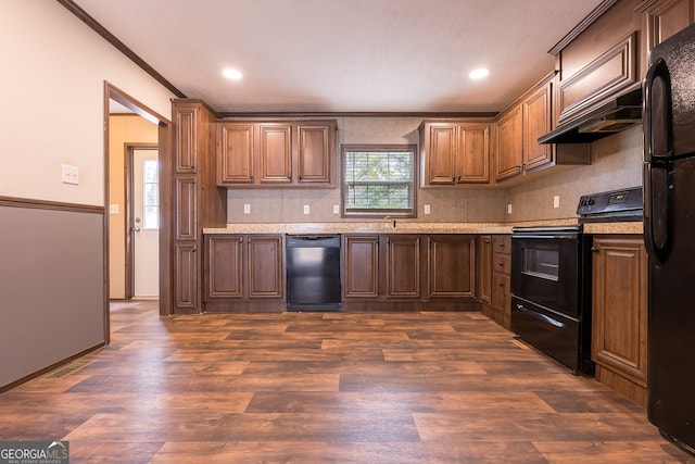 kitchen featuring custom exhaust hood, dark hardwood / wood-style flooring, black appliances, crown molding, and sink