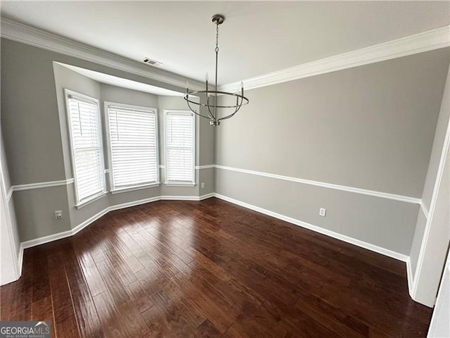 unfurnished dining area featuring crown molding, a chandelier, and dark hardwood / wood-style floors