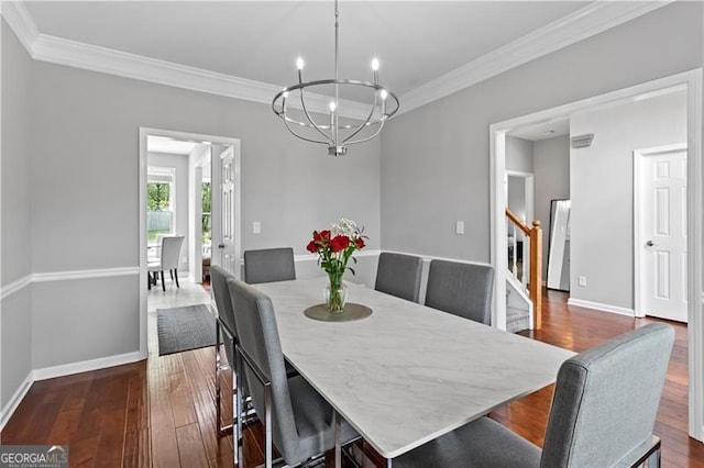 dining area with crown molding, dark hardwood / wood-style flooring, and a chandelier