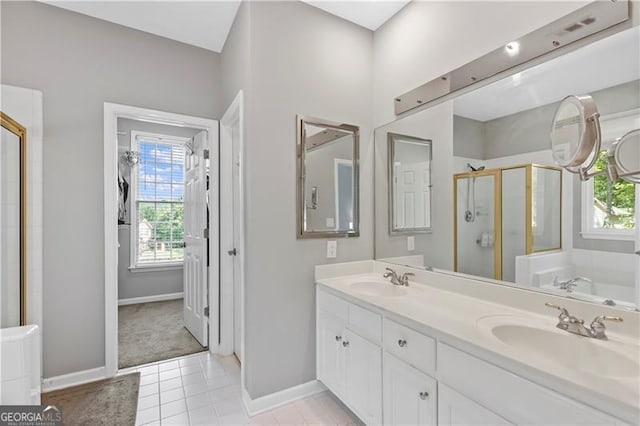 bathroom with plus walk in shower, vanity, tile patterned floors, and a healthy amount of sunlight