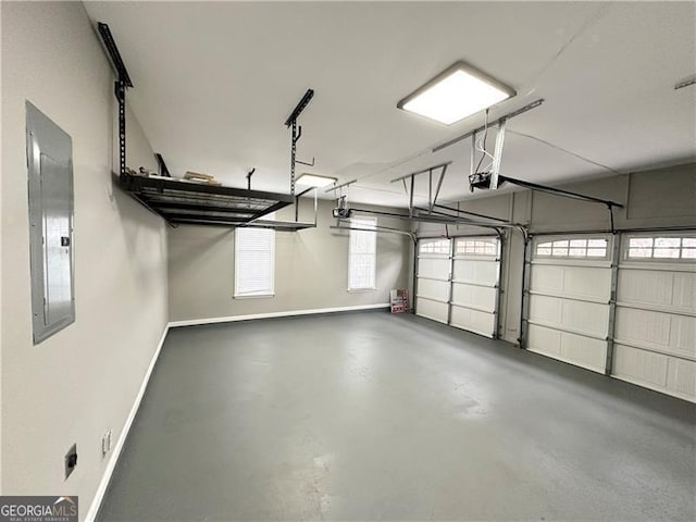 garage with a garage door opener and electric panel