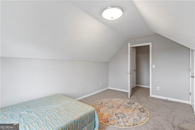 bedroom with carpet and lofted ceiling