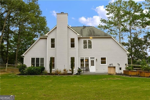 rear view of property with a lawn and a patio area