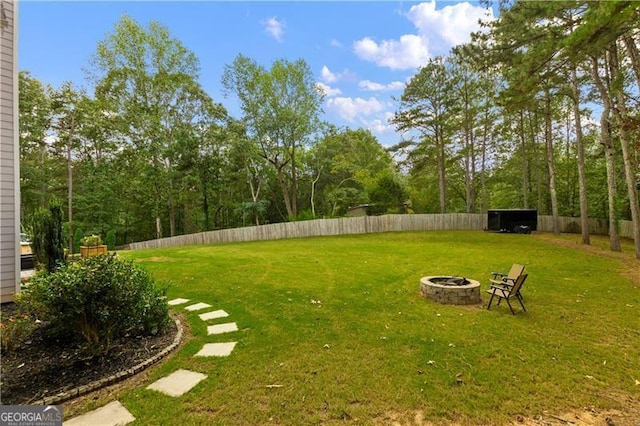 view of yard with an outdoor fire pit