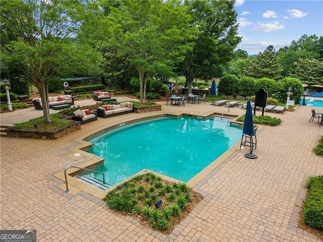 view of pool with a patio area and an outdoor hangout area