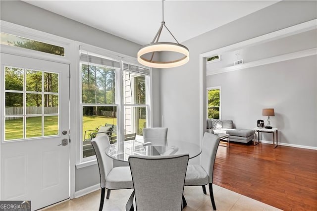 dining area featuring plenty of natural light and light wood-type flooring