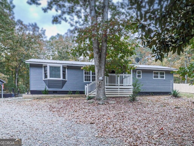 ranch-style home with a wooden deck