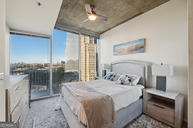 carpeted bedroom with multiple windows, floor to ceiling windows, and ceiling fan