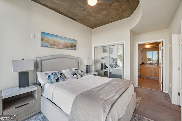 bedroom featuring a closet, ceiling fan, carpet flooring, and ensuite bathroom