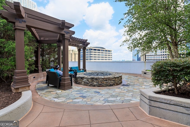 view of patio with a pergola and a fire pit