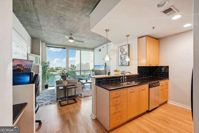 kitchen with light brown cabinets, light hardwood / wood-style flooring, kitchen peninsula, sink, and stainless steel dishwasher