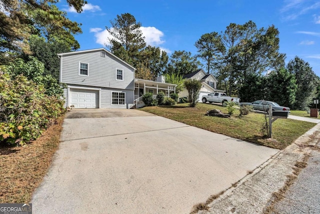 view of front facade with a garage and a front lawn