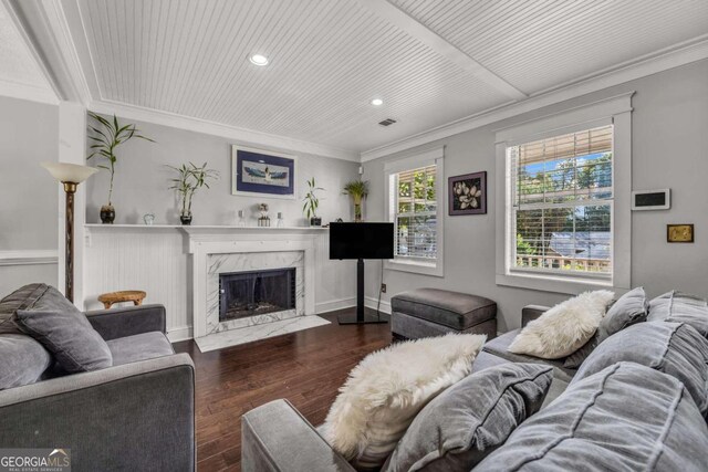 living room featuring ornamental molding, dark hardwood / wood-style floors, and a premium fireplace