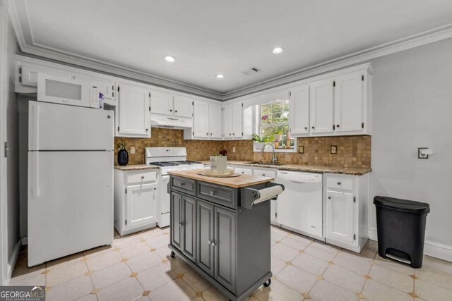 kitchen with ornamental molding, sink, a center island, white cabinetry, and white appliances