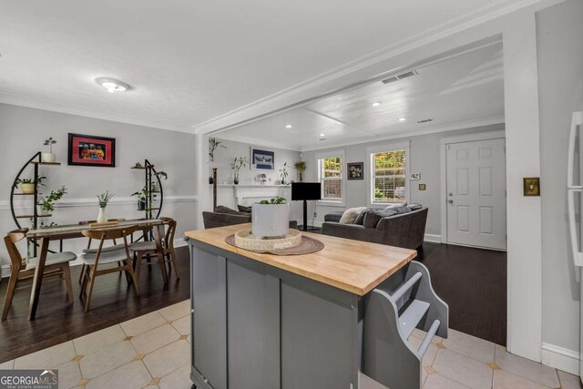 kitchen with ornamental molding, gray cabinetry, and light wood-type flooring