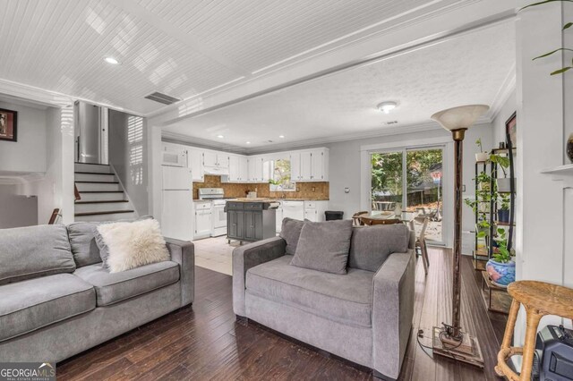 living room featuring ornamental molding and dark hardwood / wood-style flooring