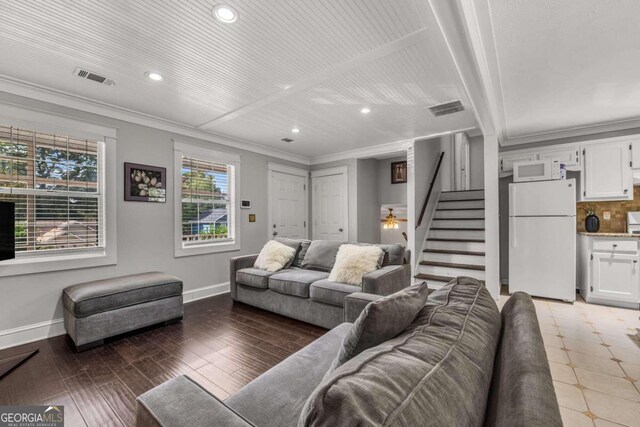 living room with crown molding and hardwood / wood-style floors