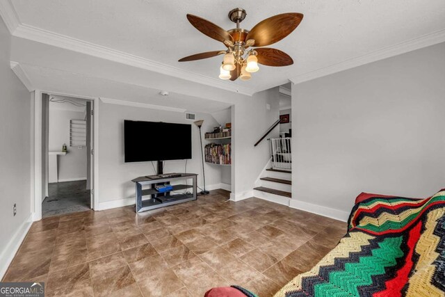 living room with ceiling fan and crown molding