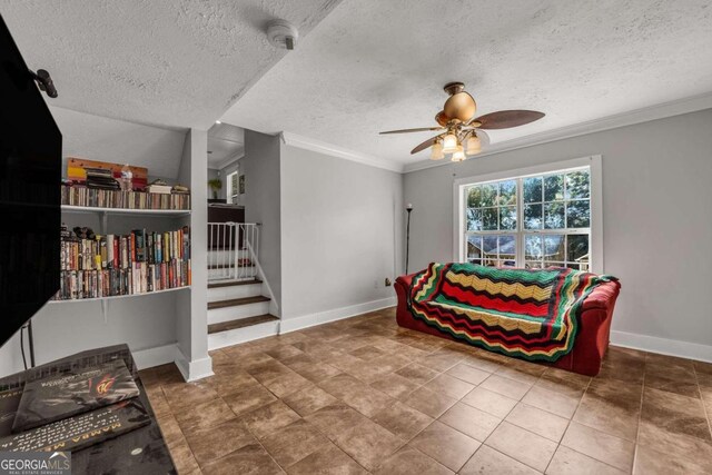 sitting room with ornamental molding, a textured ceiling, tile patterned floors, and ceiling fan