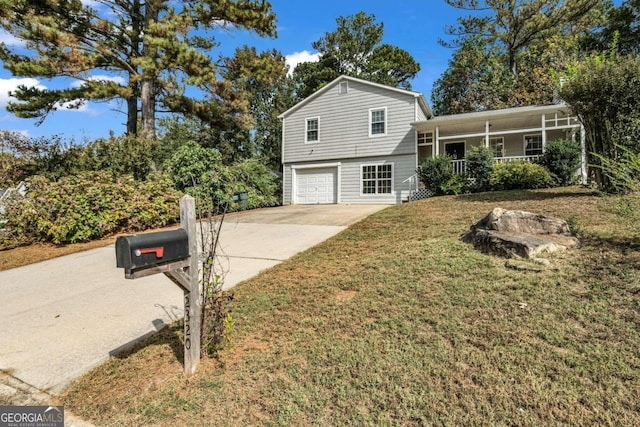 tri-level home featuring a front yard and a garage