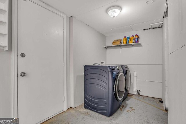 laundry area with washing machine and clothes dryer