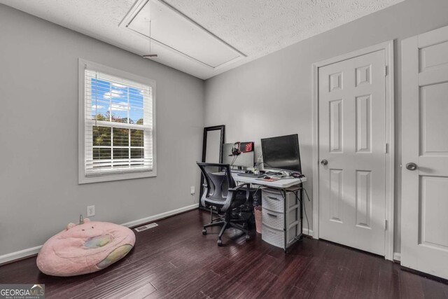 office featuring a textured ceiling and dark wood-type flooring