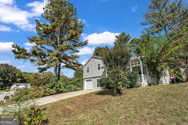 view of side of home with a lawn and a garage